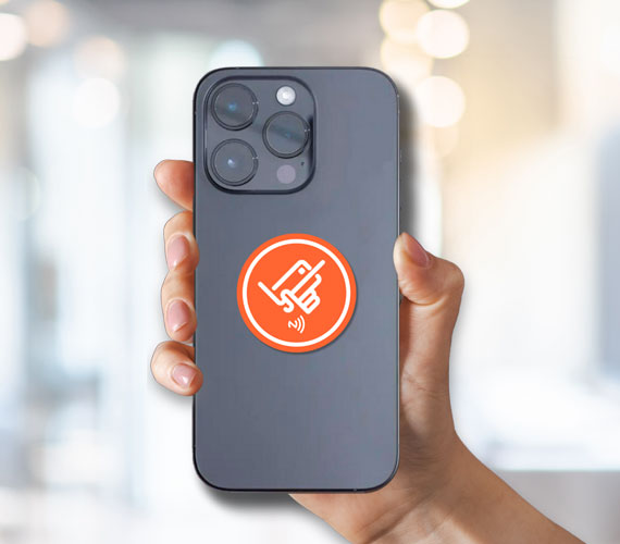 DigiVCard NFC sticker attached to a smartphone, enabling tap-to-connect digital business card sharing.